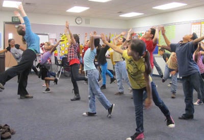 group of students learning a dance move