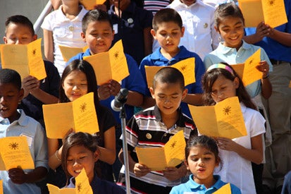 group of students reading a poem from a book