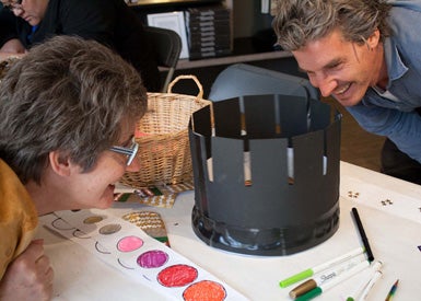 Two people looking at a zoetrope