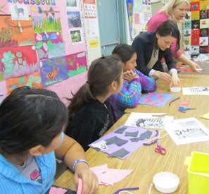 students watching a demonstration of an art project